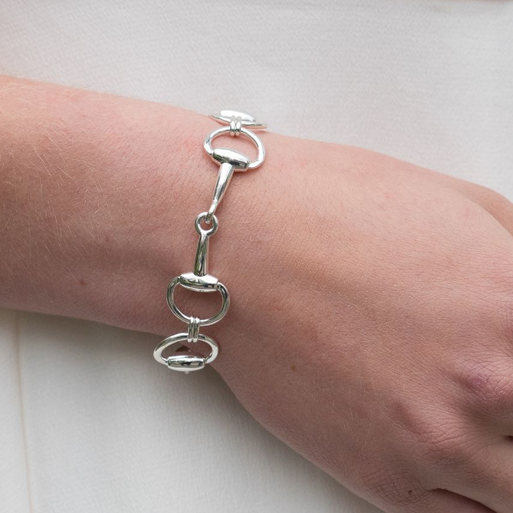 
                  
                    Silver Snaffle bracelet on a wrist against a white background
                  
                