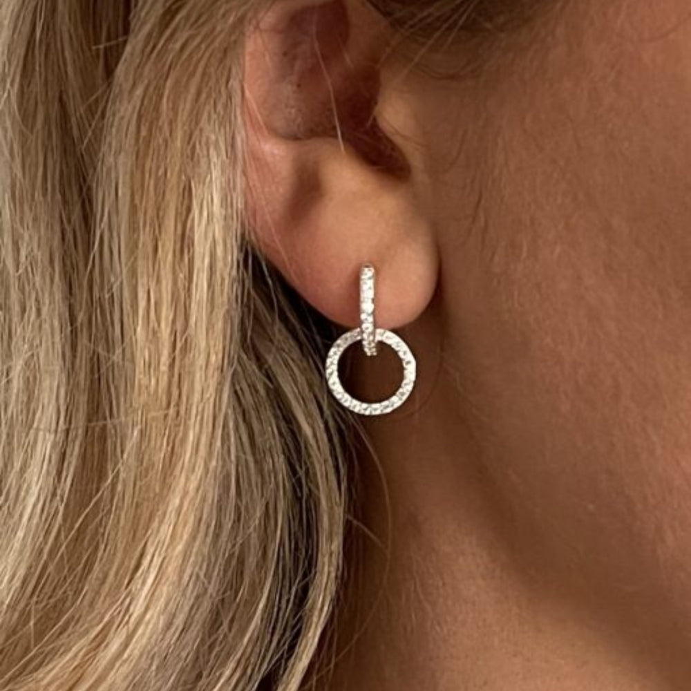 model wears cz silver circle huggie earrings