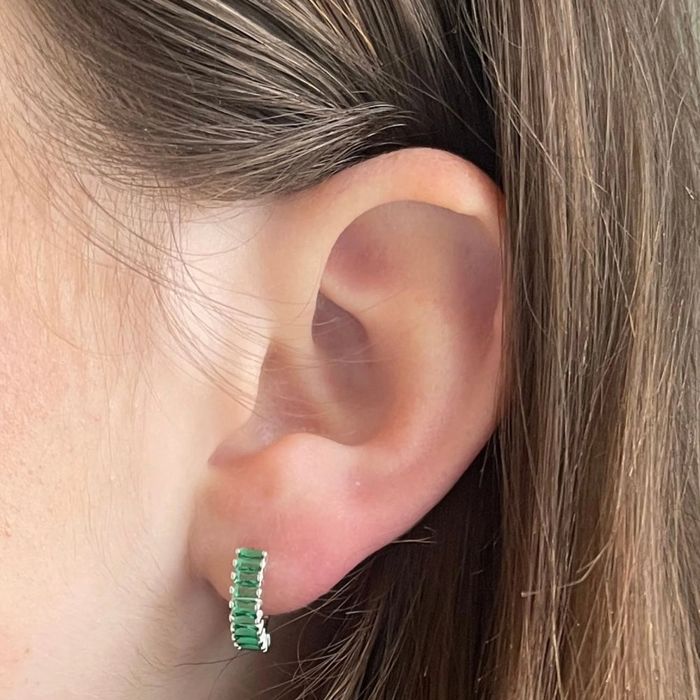 
                  
                    model wears silver and  green holiday huggie earrings
                  
                