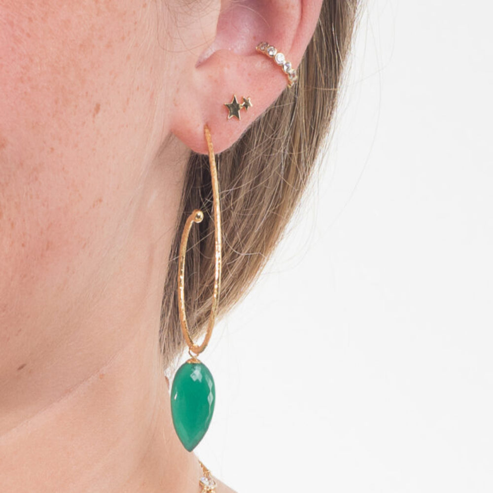 
                  
                    model wears large gold hoop with gree onyx drop in ear
                  
                