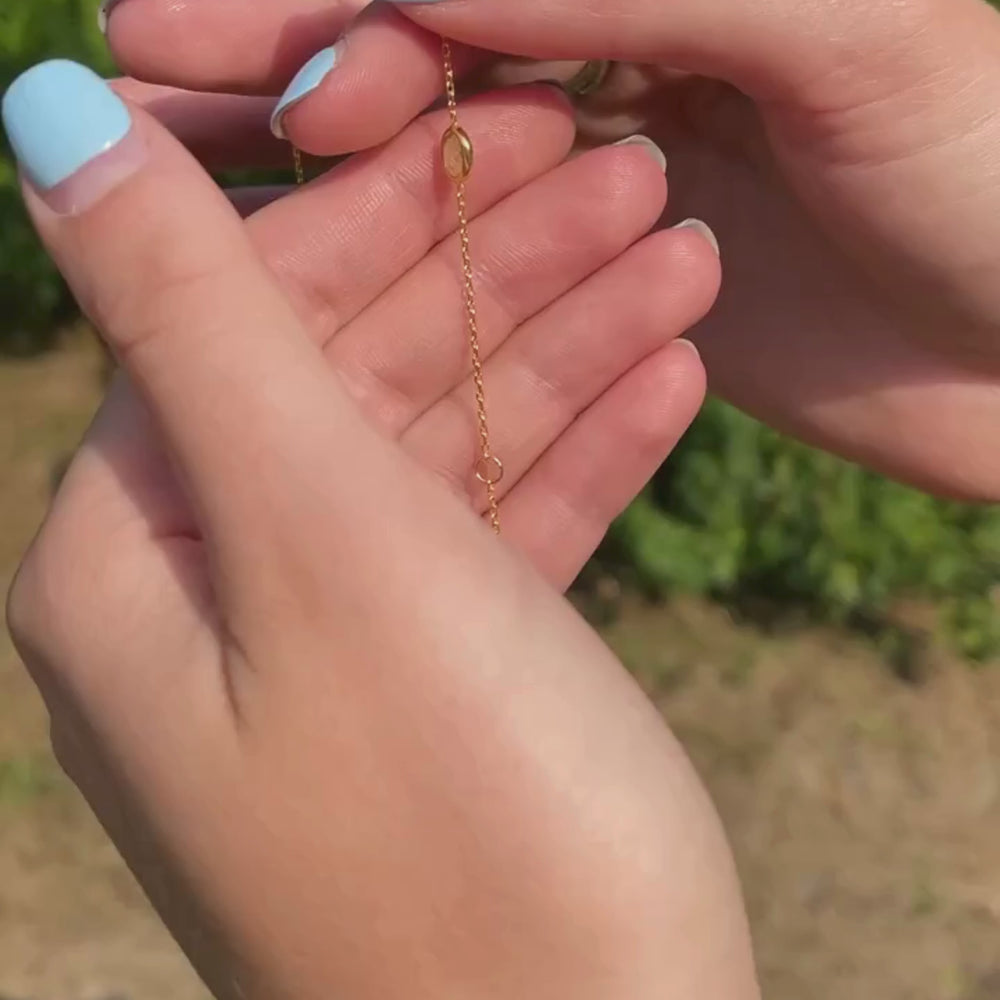 Model shows gold peridot bracelet