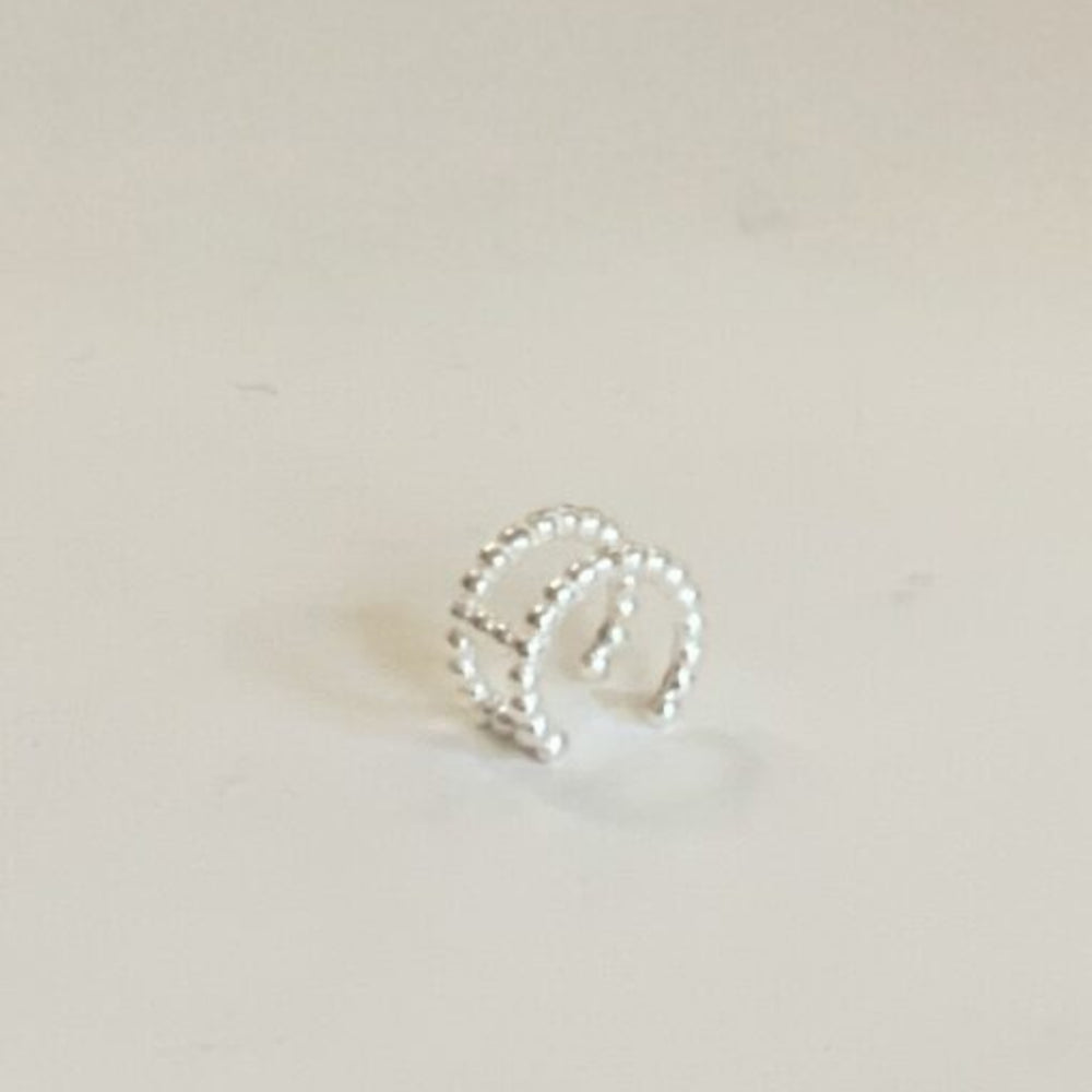 silver double row bobble ear cuff on tile