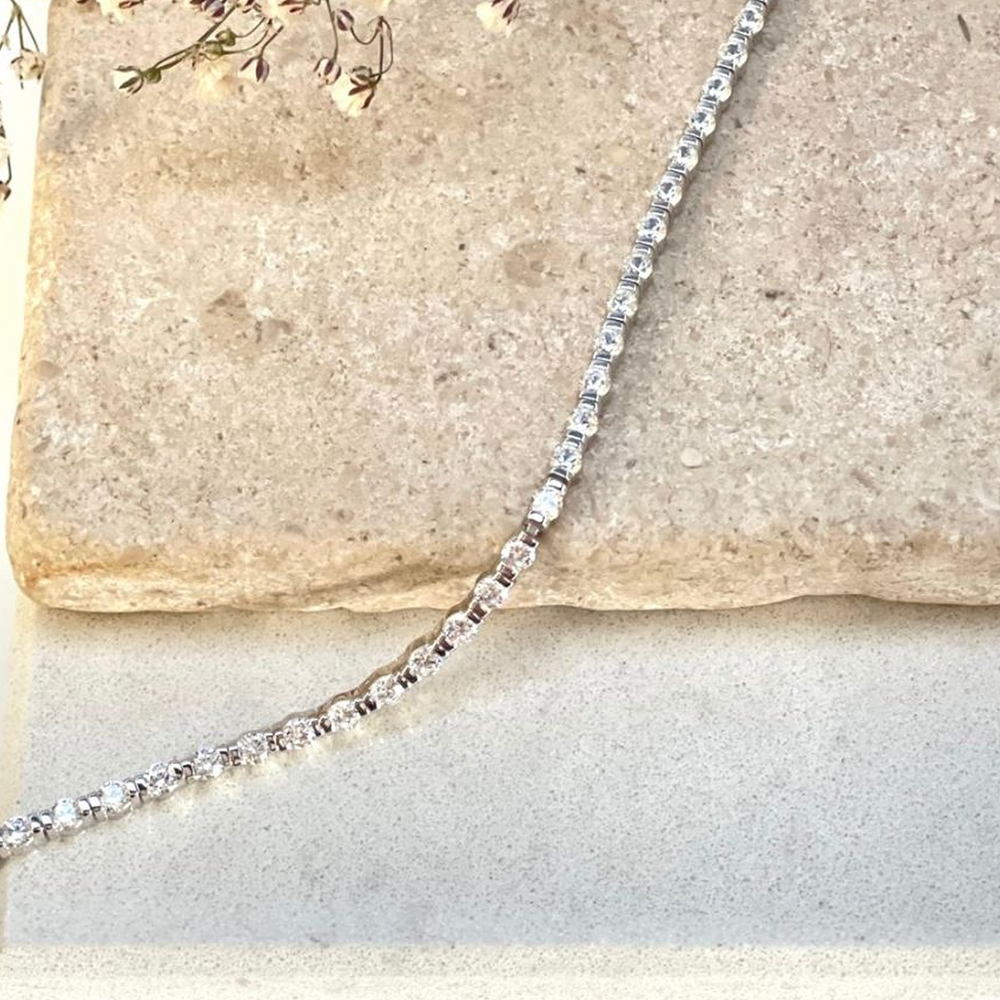 Tia Tennis Bracelet draped on a tile