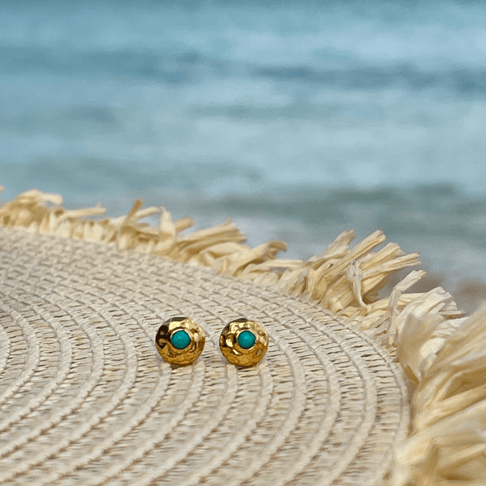 
                  
                    turquoise adn gold studs on hat
                  
                