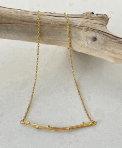 Gold Twig Necklace on tile